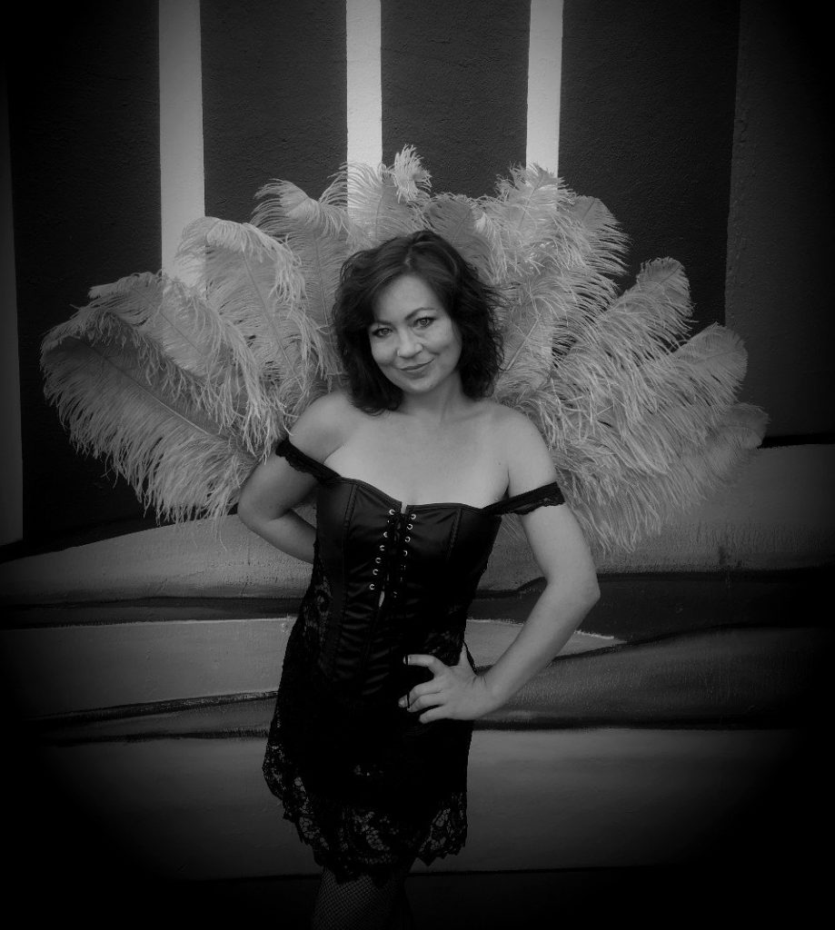 Posing with a giant ostrich feather fan